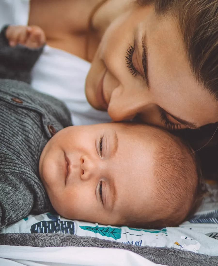 A close-up photo of a mother and baby with a small Cora AI chip