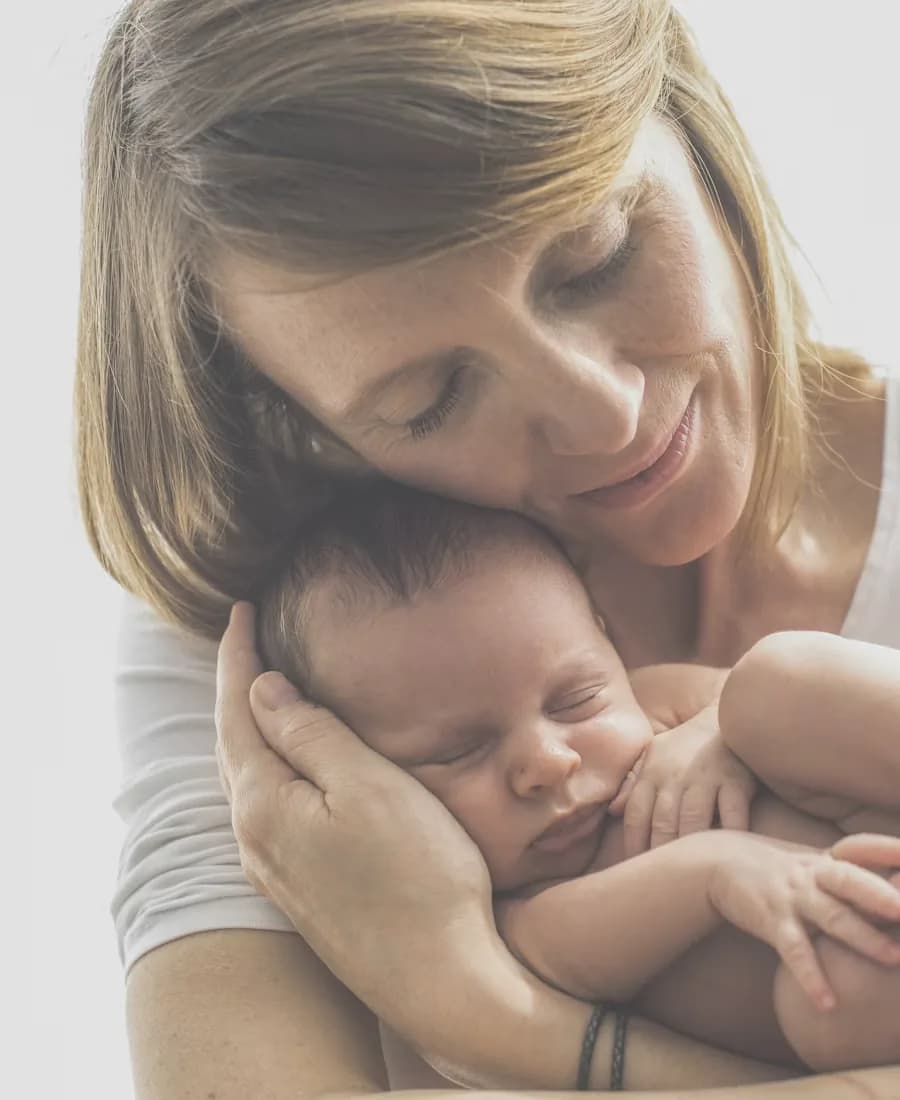 A mother holding her baby beside a live session timer card